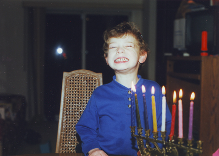Louis shows his smile in front of the Menorah