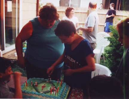 After blowing them out, Louis cuts cake